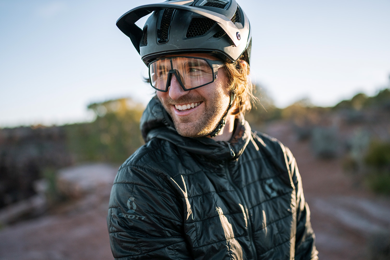 Eric doing a model pose facing the camera with his helmet on but looking over his right shoulder.