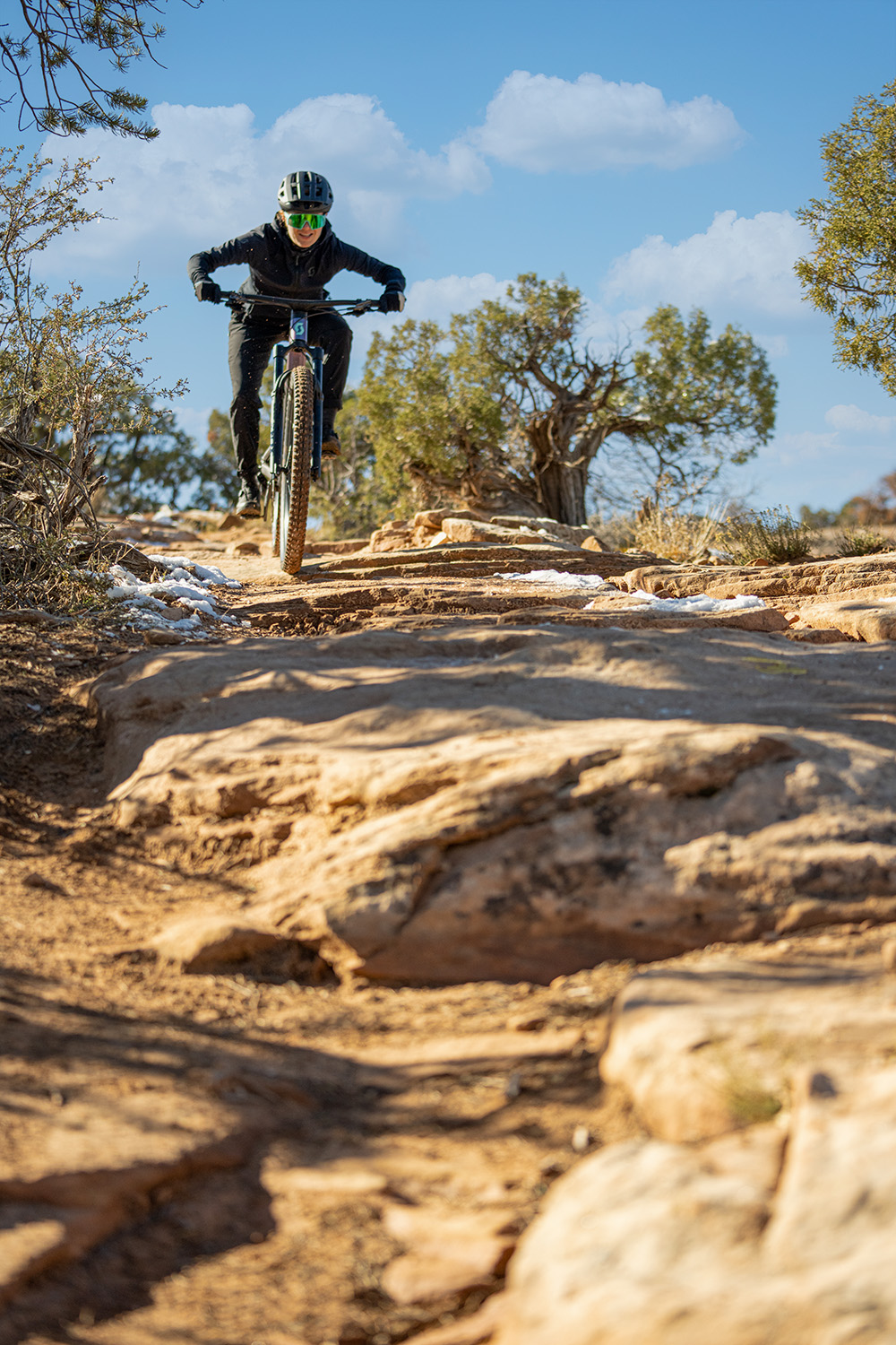 Libby riding towards the camera, riding down rocks.