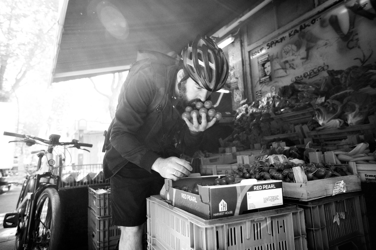 Mario smelling produce at the market
