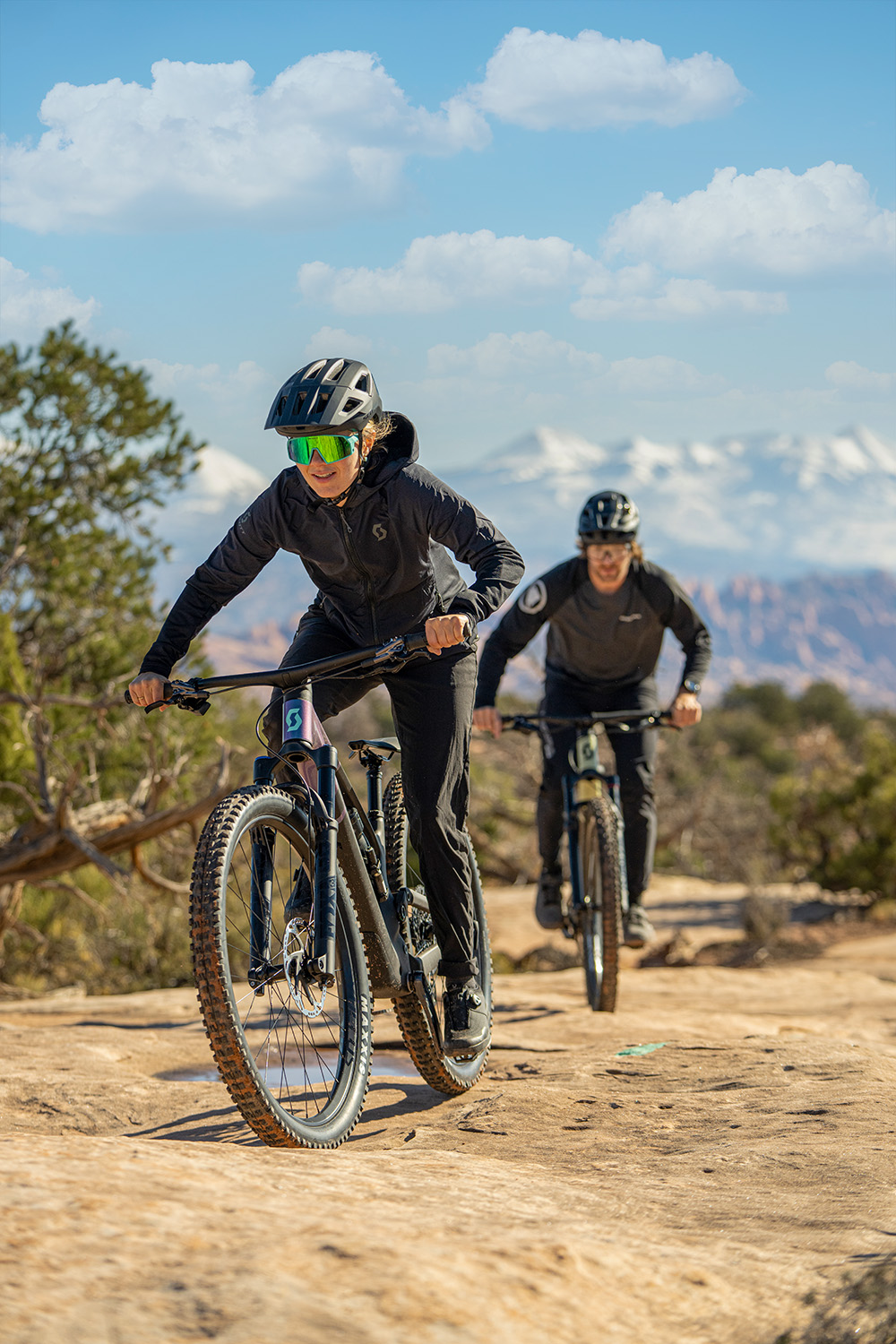 Eric and Libby riding towards the camera, riding over rocks.