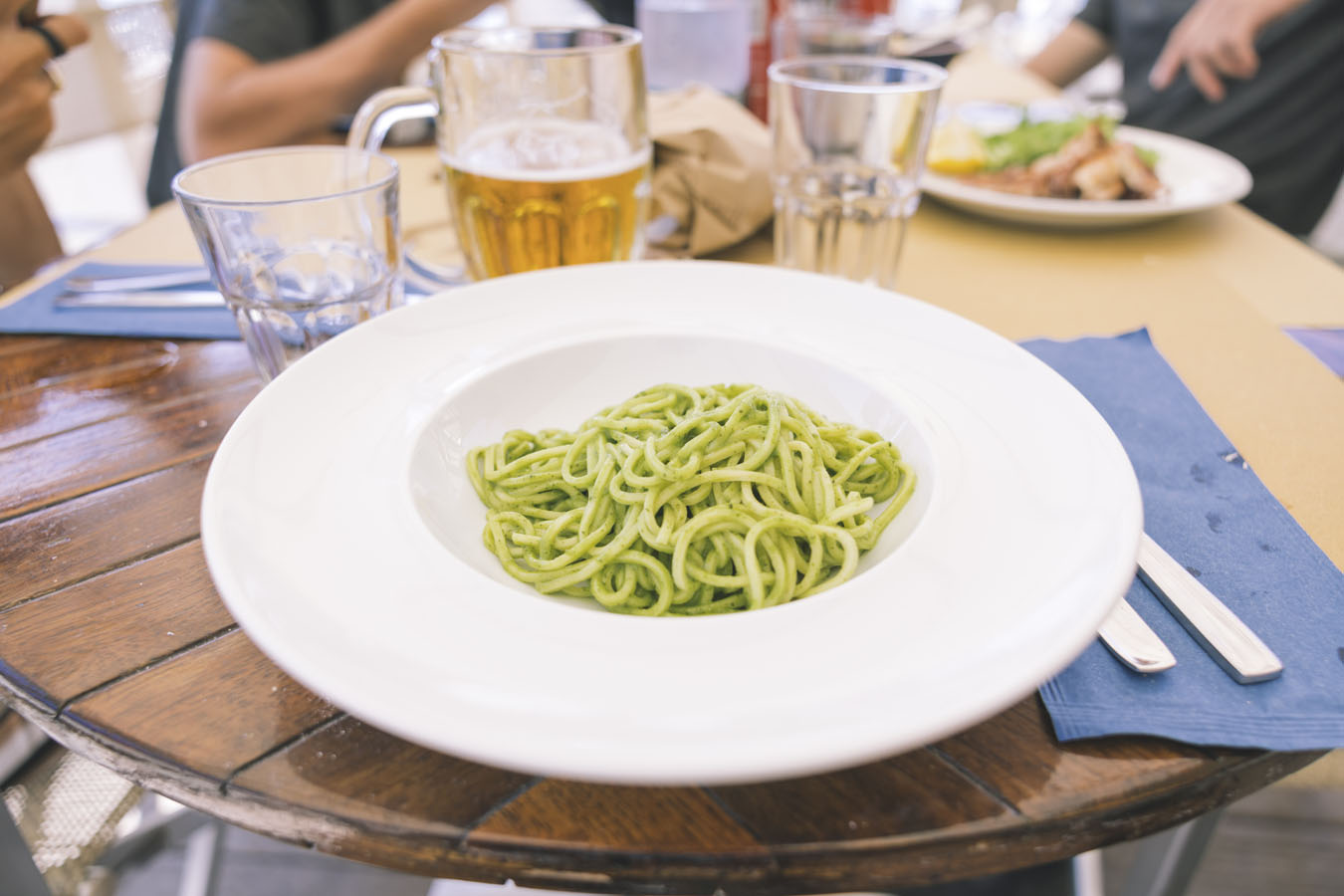Close up of plate with pesto pasta