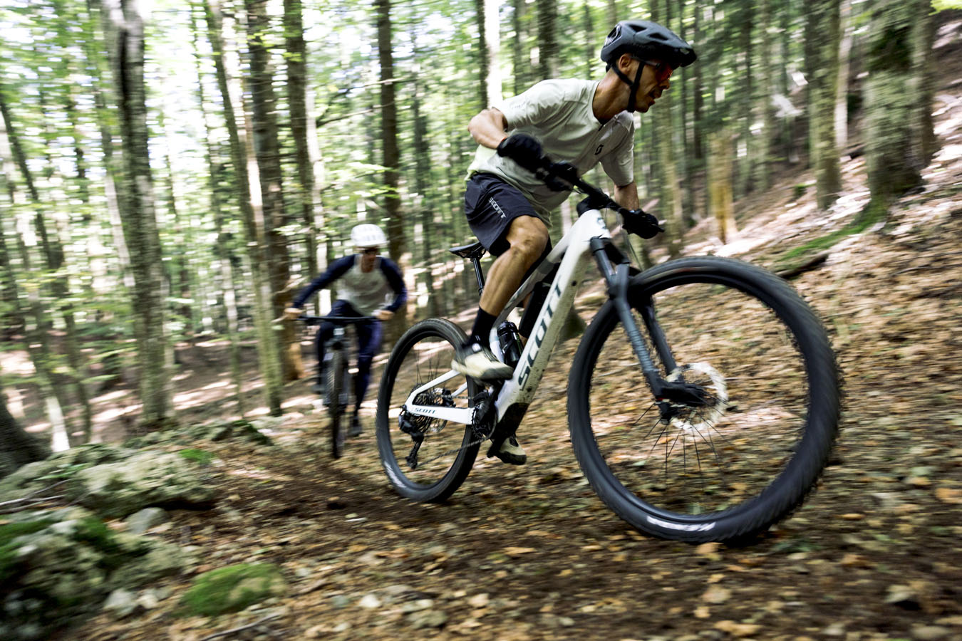 Two mountain bikers running on a top of a hill