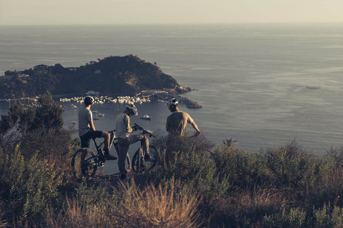 Three bikers watching the sea