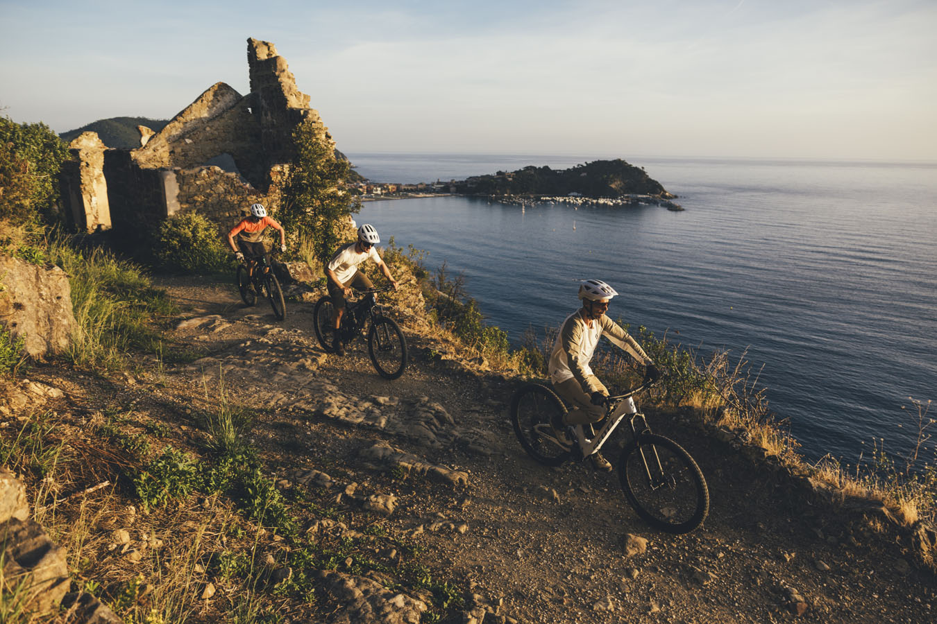 Three mountain bikers riding on the coast