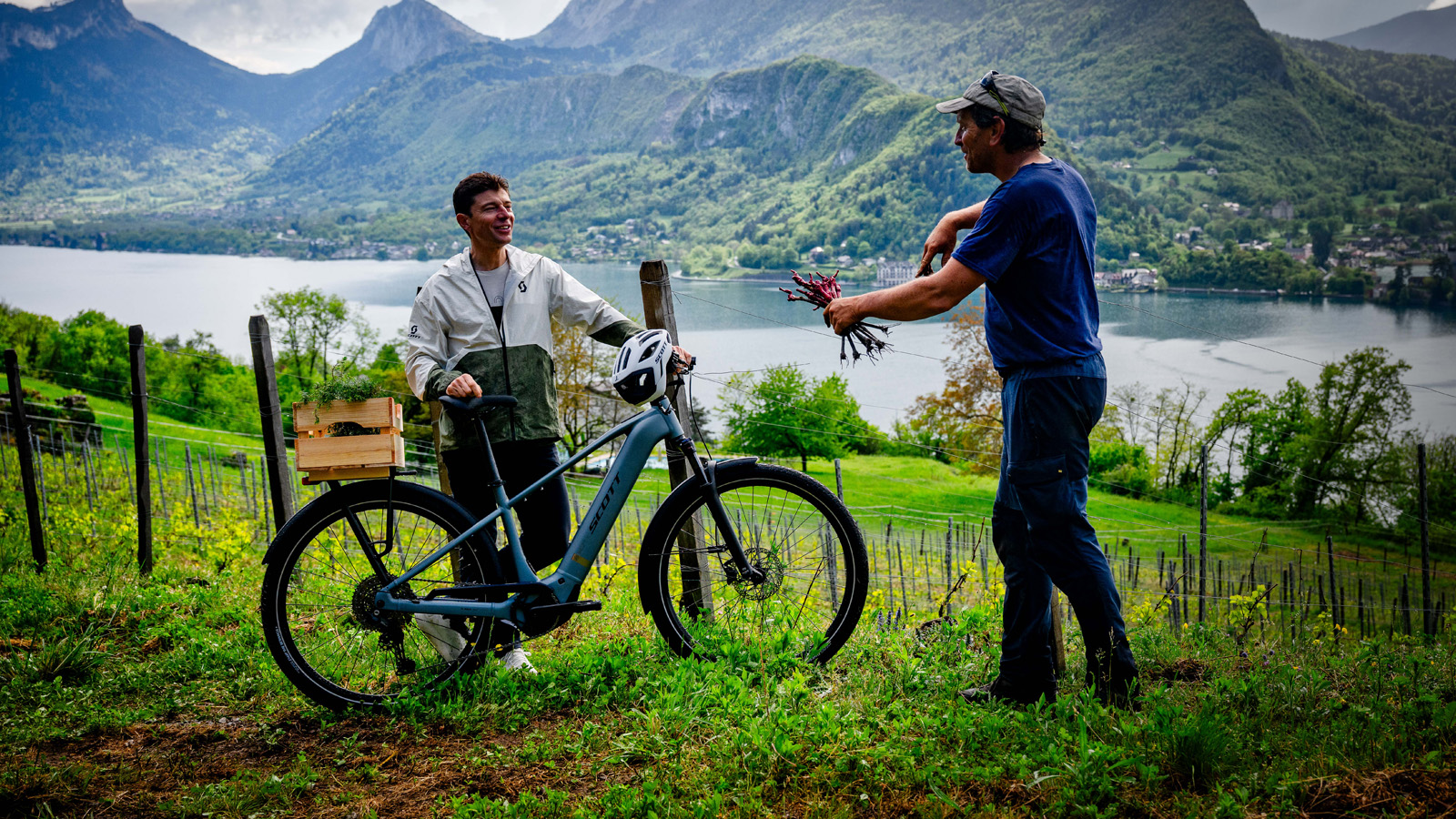 Michelin-starred chef Jean Sulpice smiling at a farmer and standing behind a SCOTT Bike