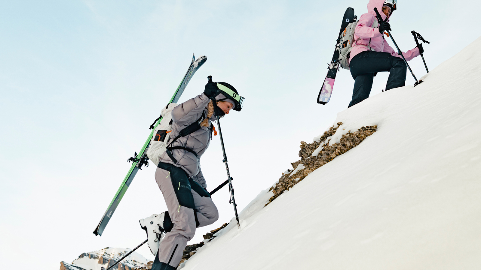 Sabine Schipflinger and Chloé Margot, SCOTT Winter ambassadors, climbing a mountian wearing Full SCOTT Gears