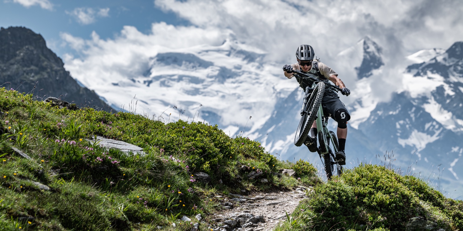 guy doing a manual down the mountain