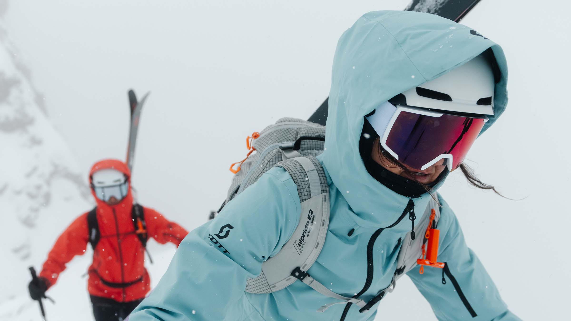 Two people ski touring wearing SCOTT goggles