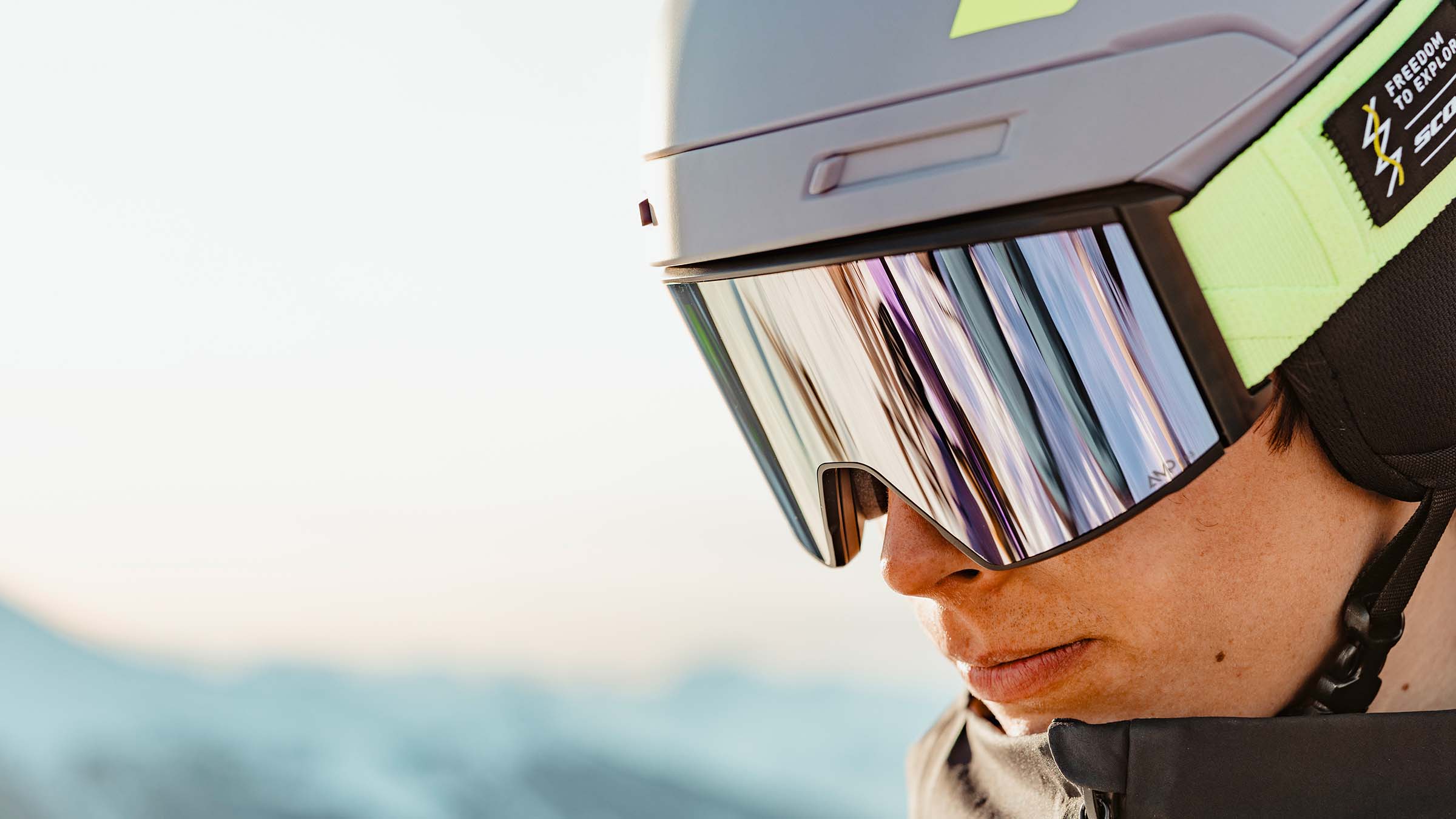 A close up of a man wearing SCOTT goggles at high elevation.