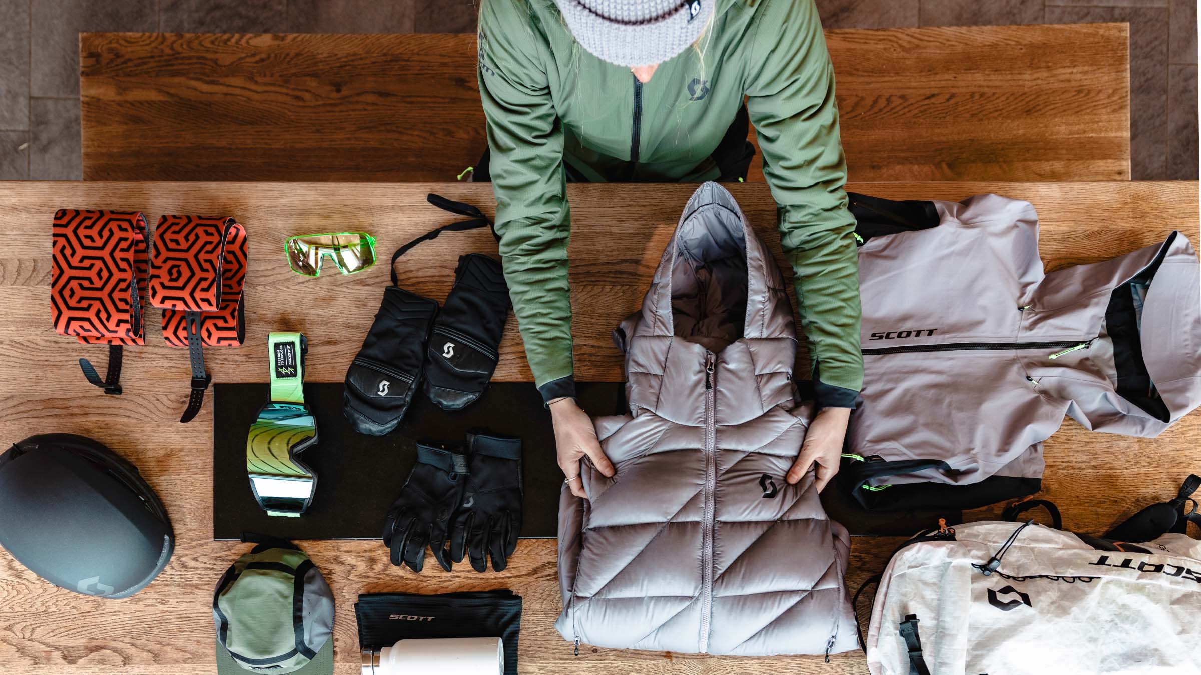 A women laying out her SCOTT gear in preparation for a backcountry skiing trip