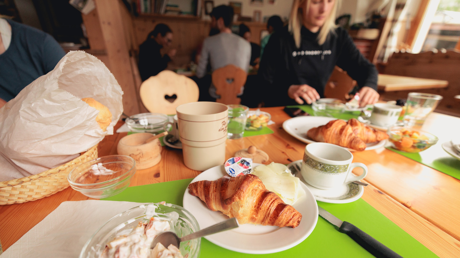 Breakfast table with Croissant and butter in a plate