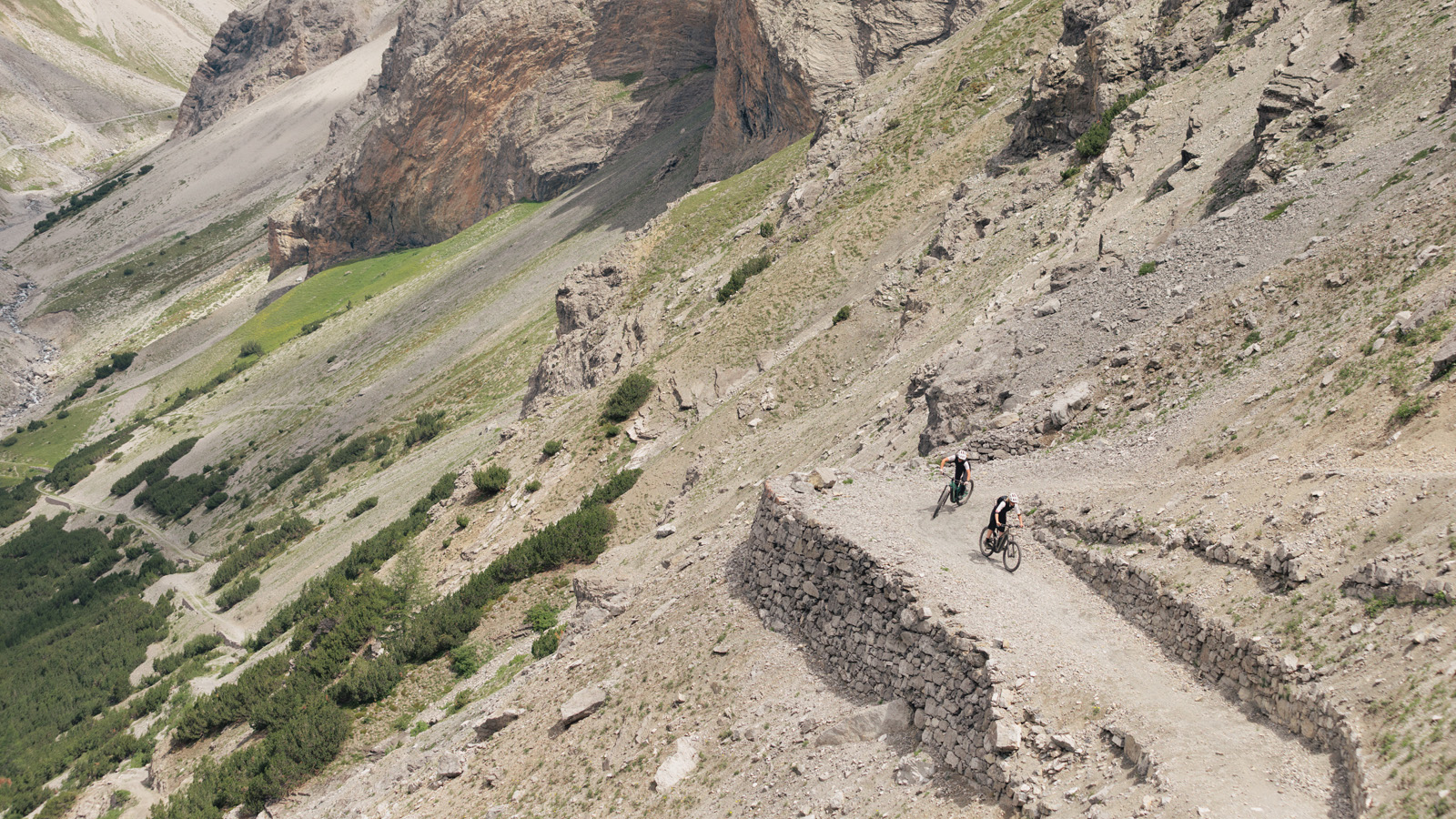 two women riding bikes in the mountains