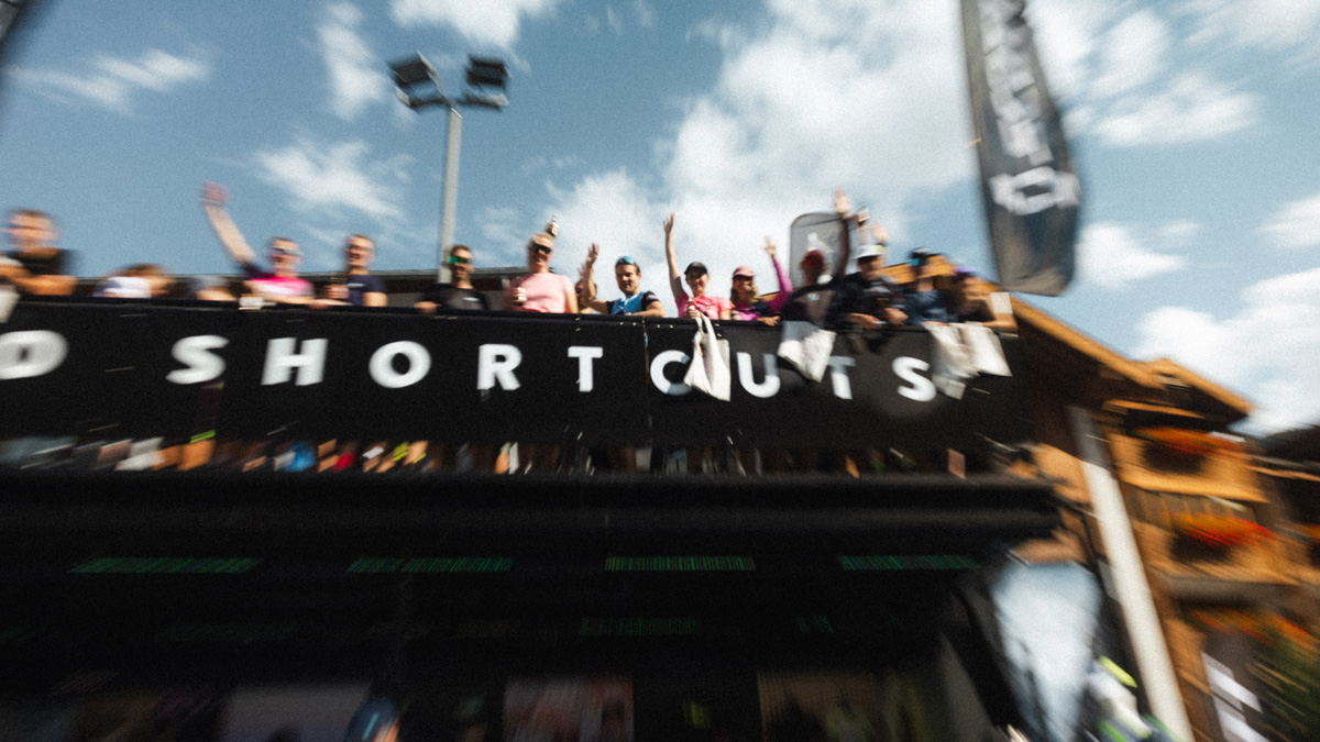 Picture with a blurred effect showing people on the top of a truck during a sport event