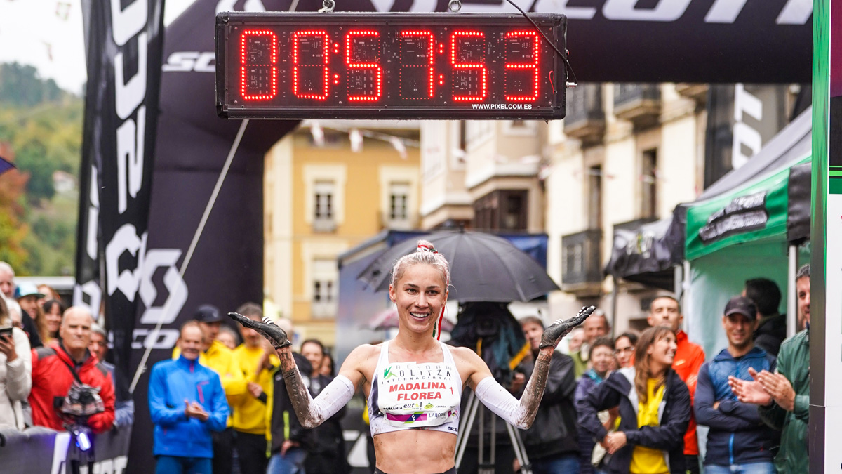 Madalina Florea standing in front of a stopwatch in sports gears