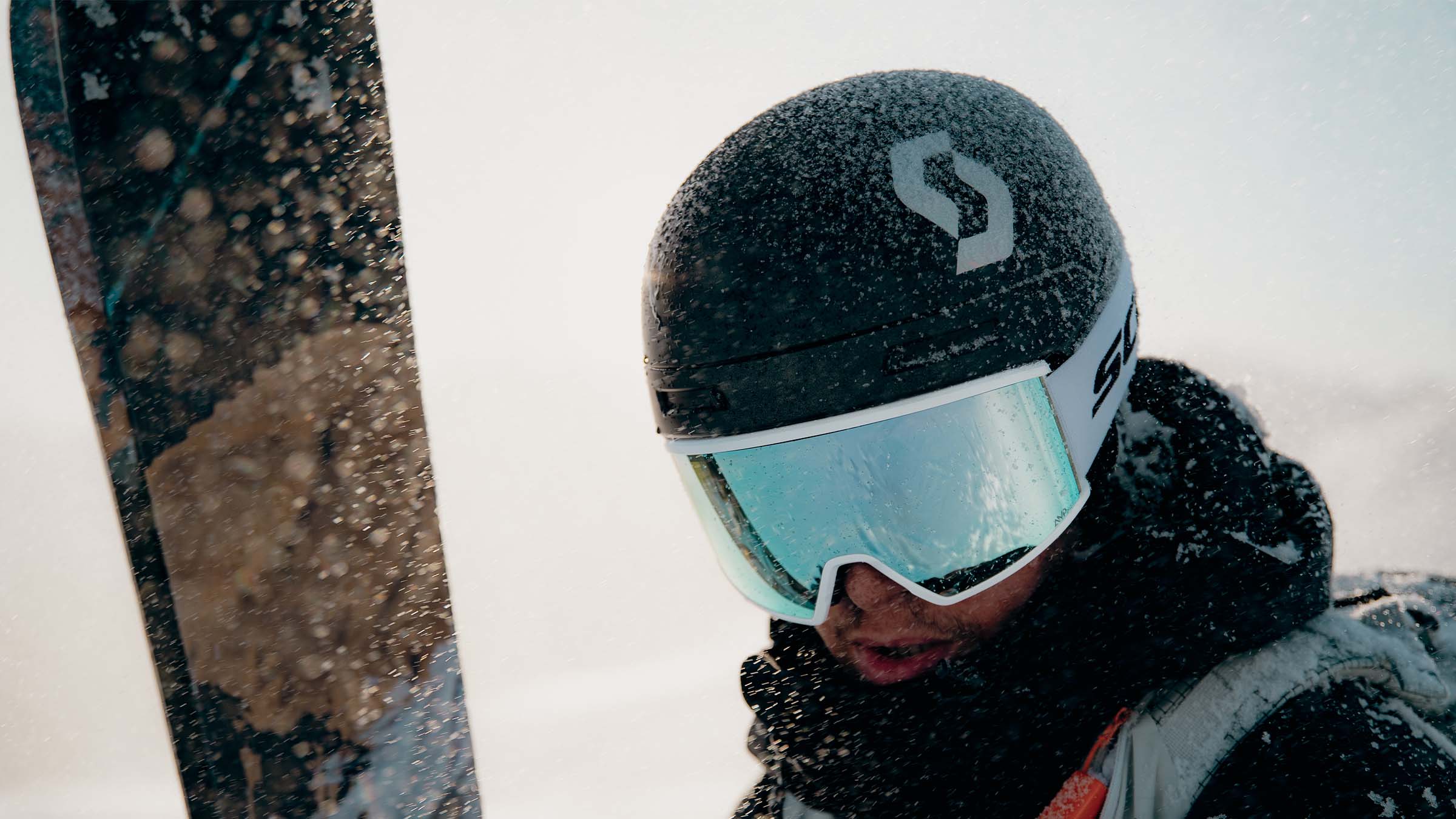 SCOTT How to Choose a Ski Helmet - close up image of a skier focusing on helmet, goggles and skis
